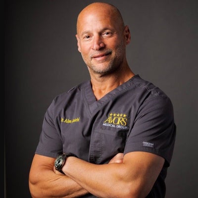 Dr. Alon Antebi in orthopedic surgical scrubs